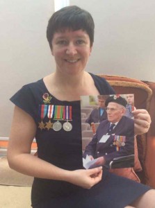 Carol Morris with a photo of her granddad and wearing his medals.