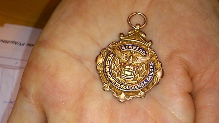 A close-up of Sarah Lee's WW1 solid gold servicemen's thank you present from the Bowness community.